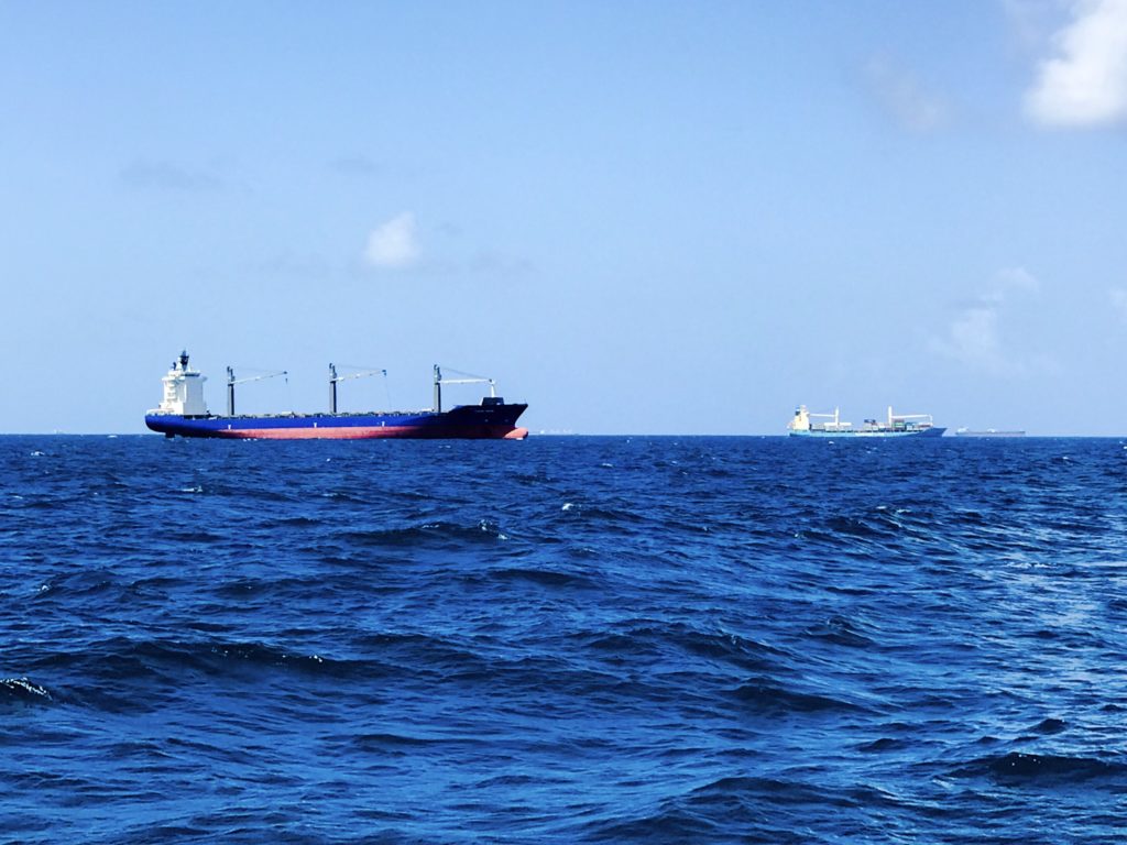 Cargo Ships, Shipping Containers and large Vessels outside of breakwater.