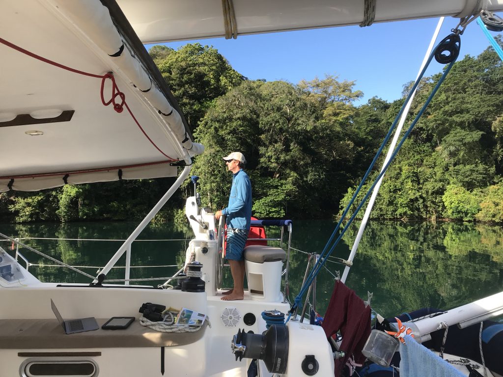 Matt at the helm with 50' trees on Rio Chagres