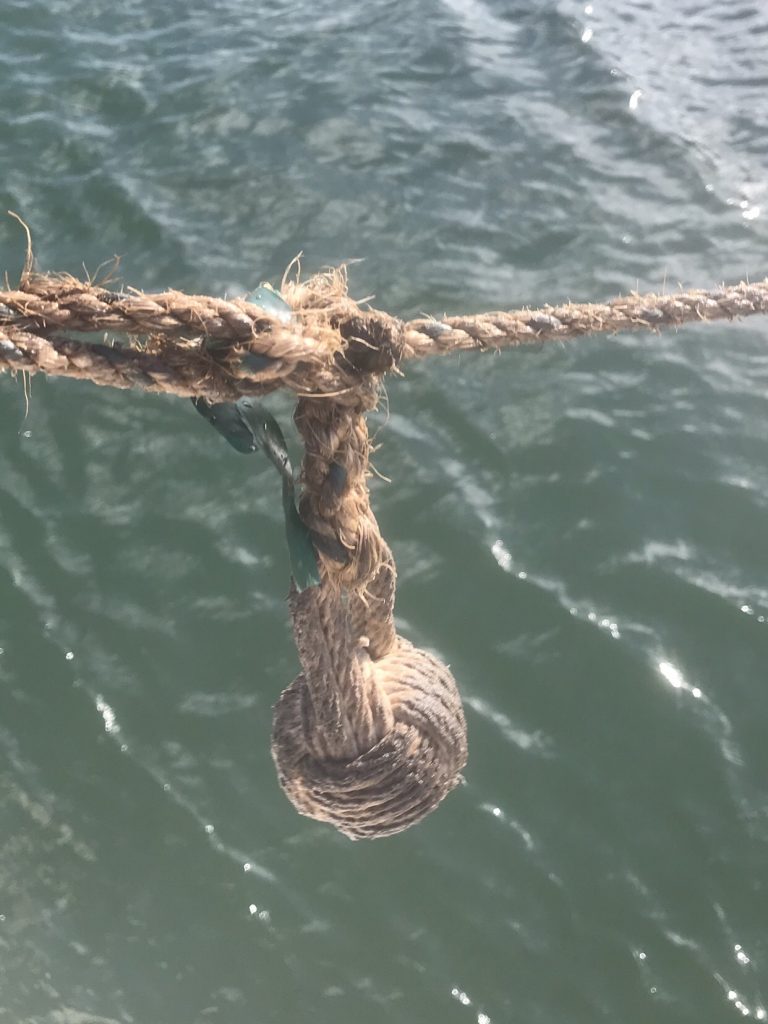 Monkey fist thrown to boat to retrieve blue lines