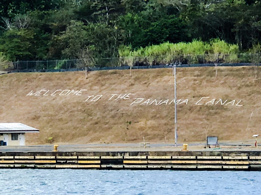 Welcome to Panama Canal sign on canal wall.