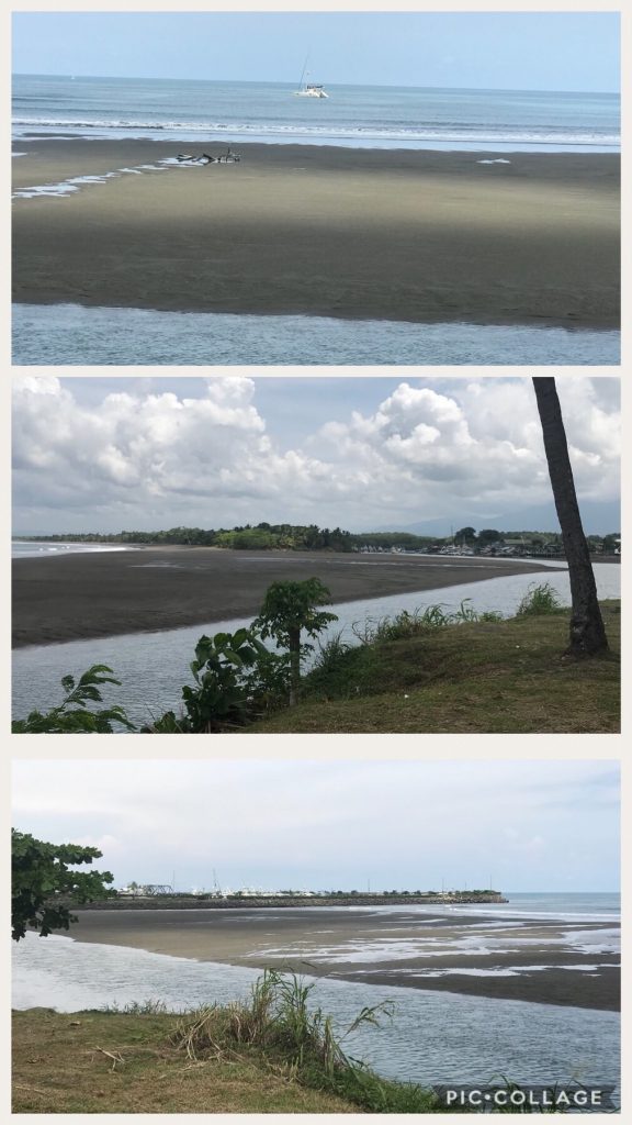Low tide exposing a river between the shore and ocean